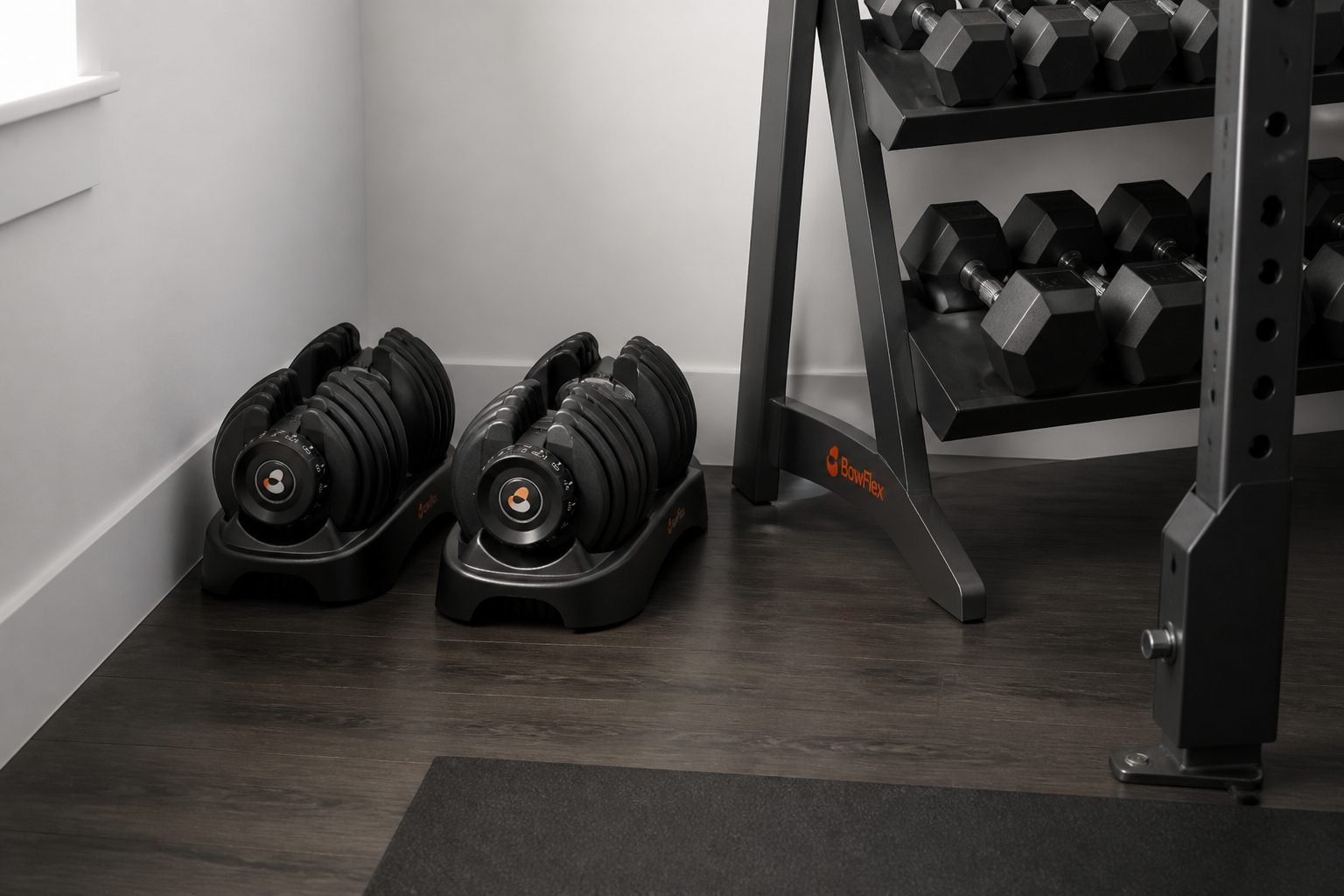 BowFlex 552 SelectTech pair stored in included trays in a compact apartment gym corner