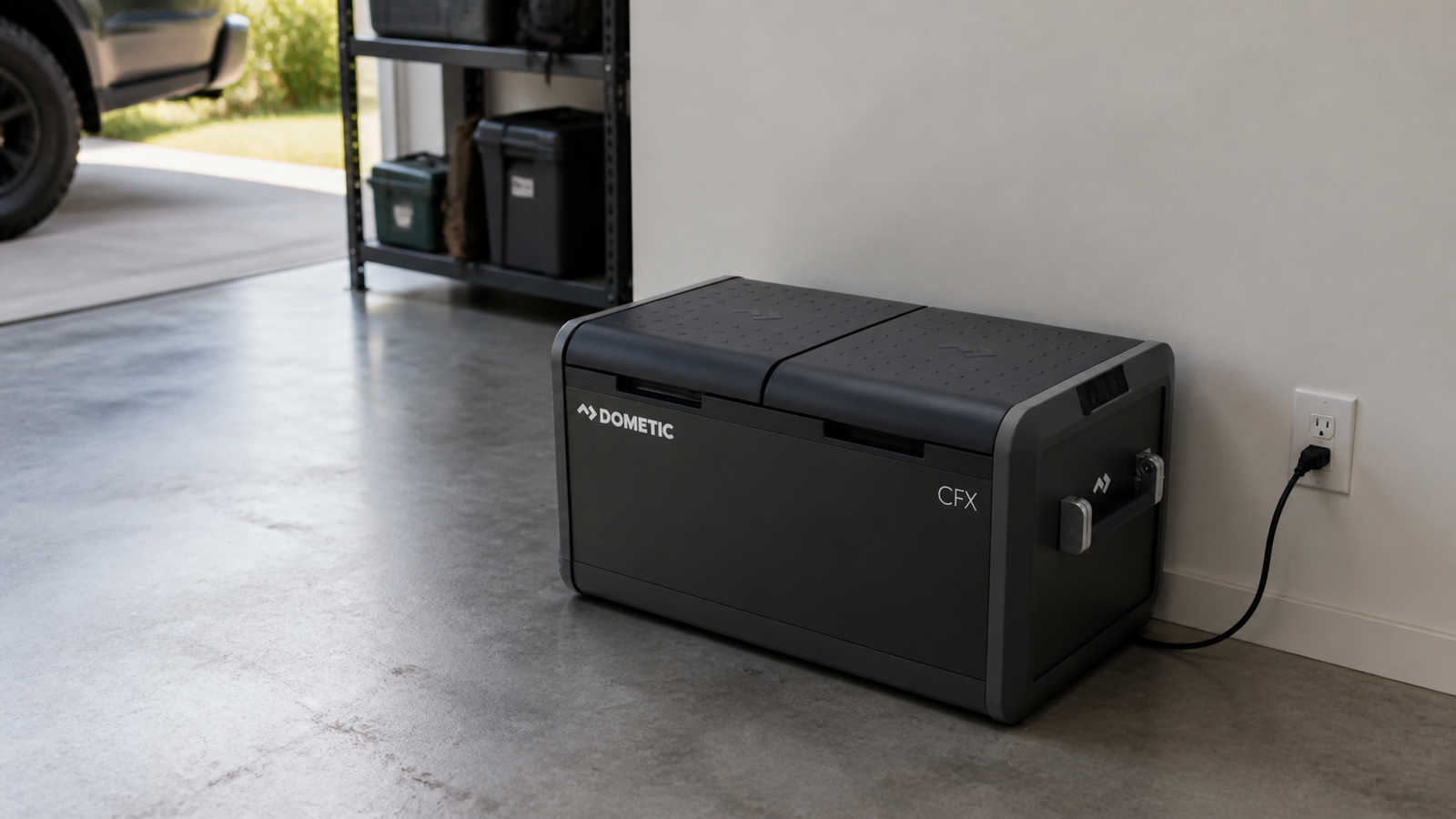 Dometic CFX5 75DZ portable freezer connected to AC power in a garage