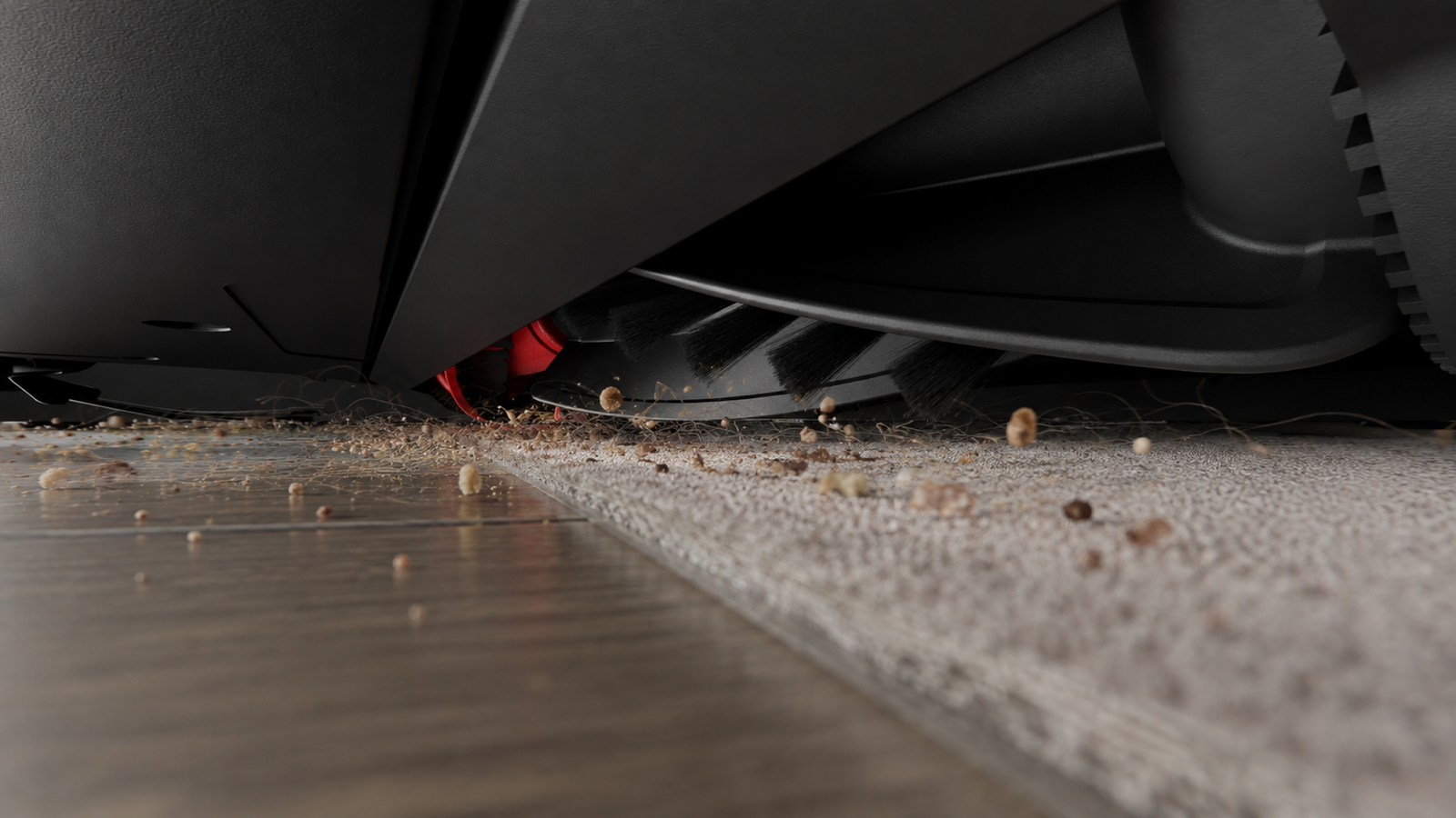 Roborock Saros 10R anti-tangle brush collecting crumbs and pet hair at a rug edge