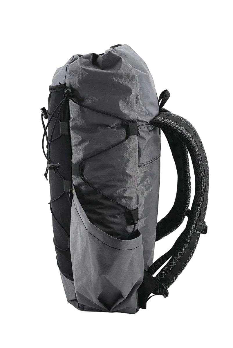 Hilltop Packs Dirty 30 ECO backpack side view in gray with side pocket and roll top