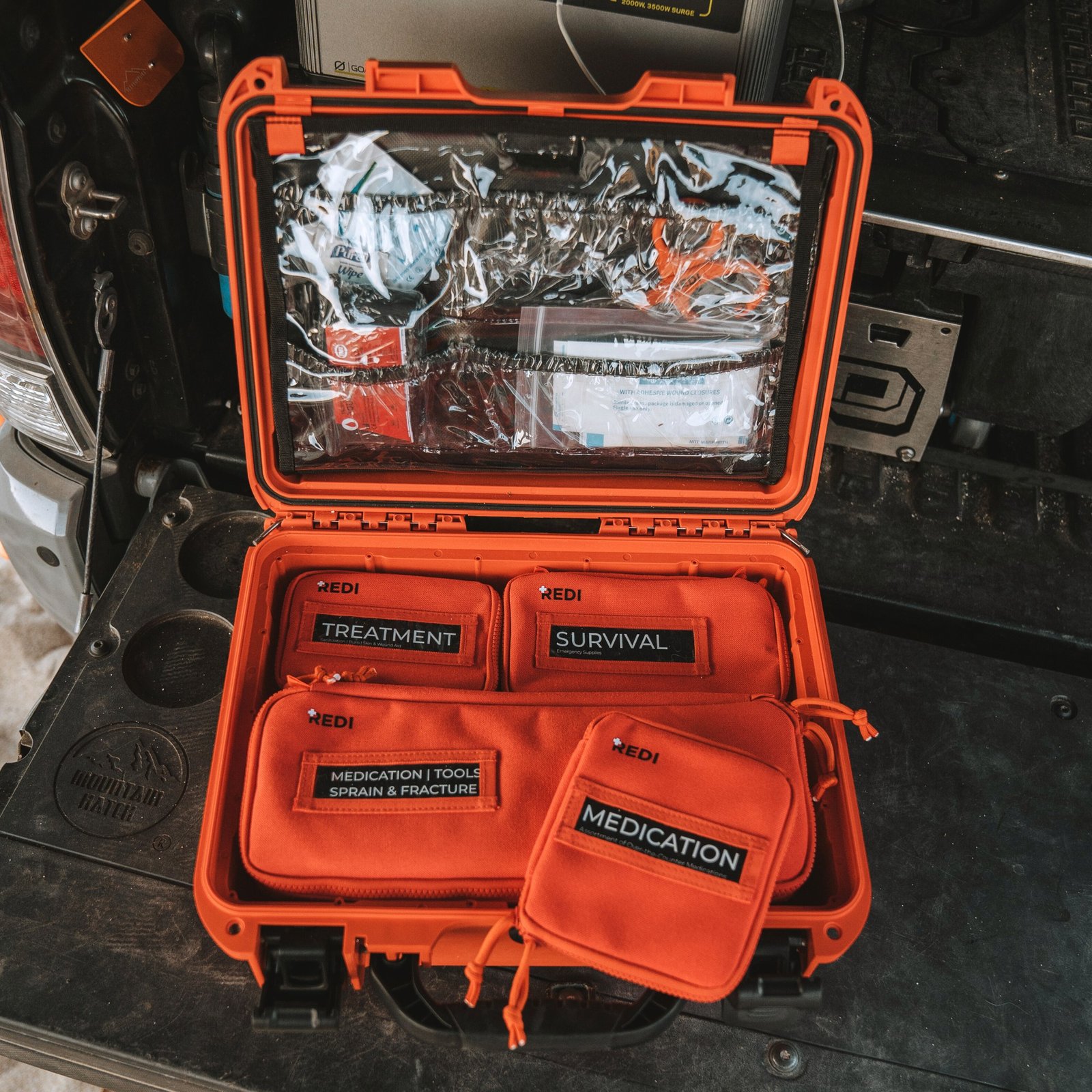 Redi Roadie Pro+ open showing PVC lid trauma compartment and labeled pouches