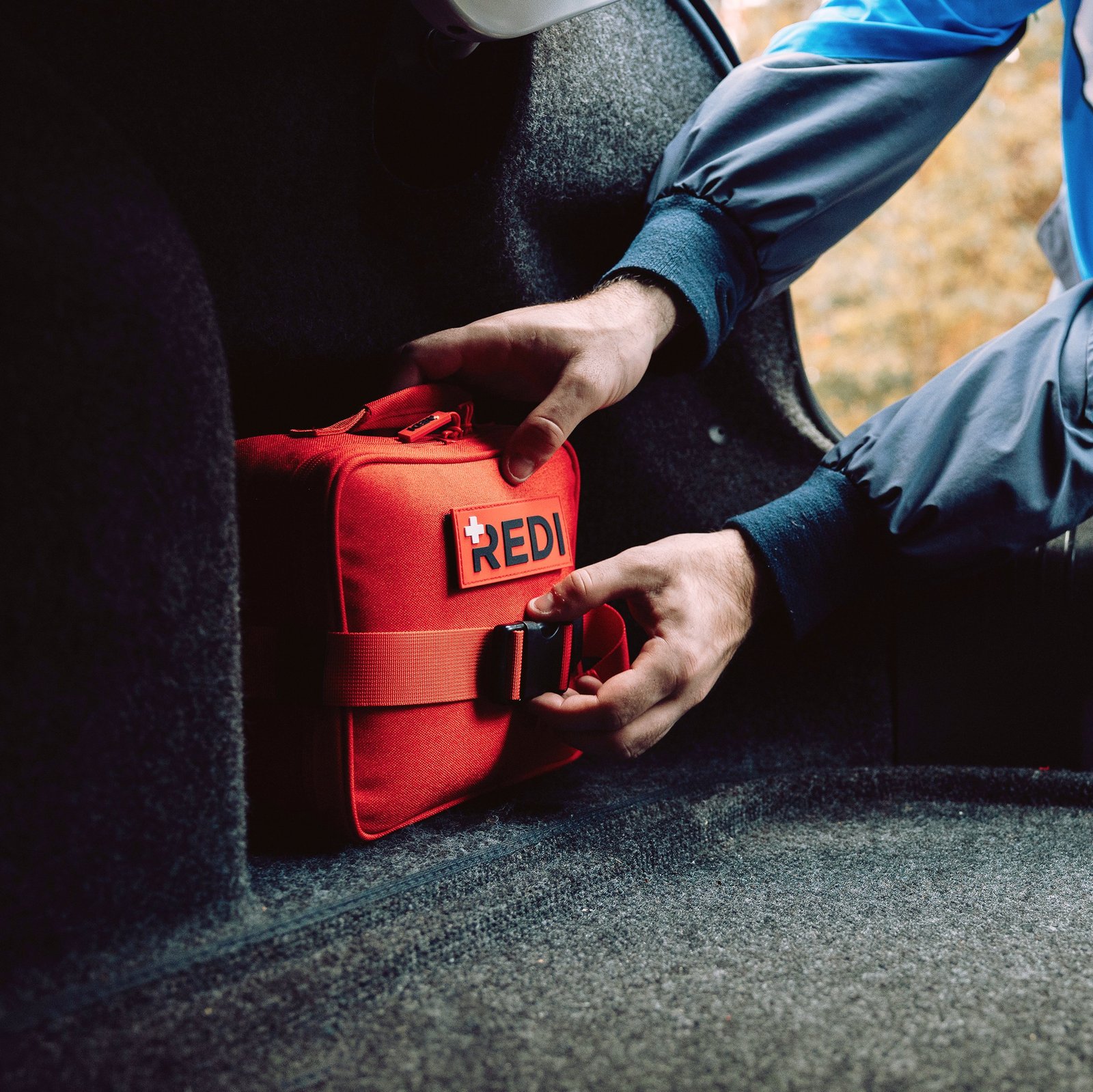Redi Roadie buckled into a carpeted vehicle cargo area